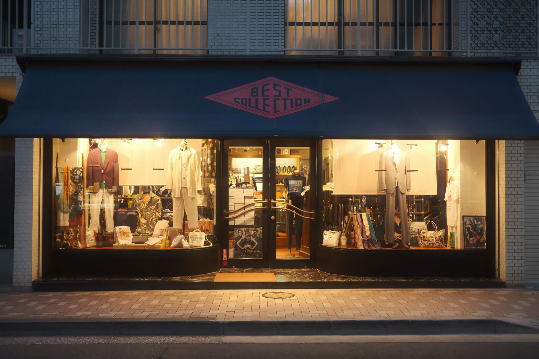 Chic boutique storefront with warm lighting at night