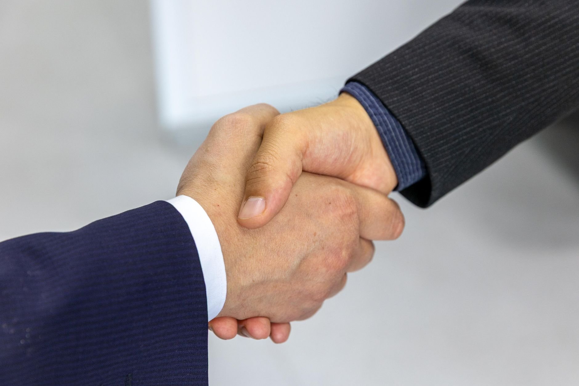 Two business partners shaking hands in a professional meeting