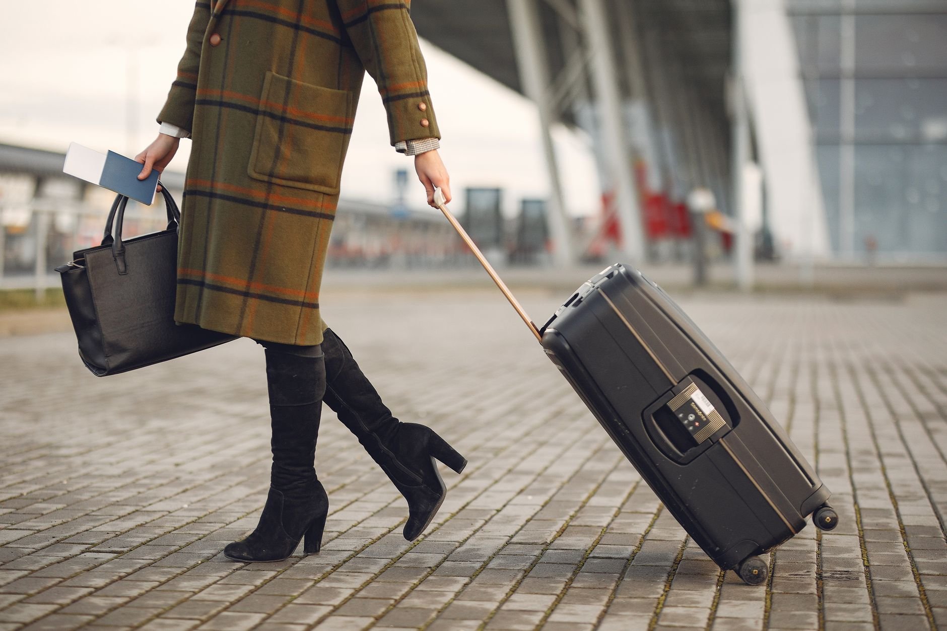 Traveller with premium luggage walking through an airport terminal